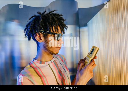 Young man with dreads playing video game Stock Photo