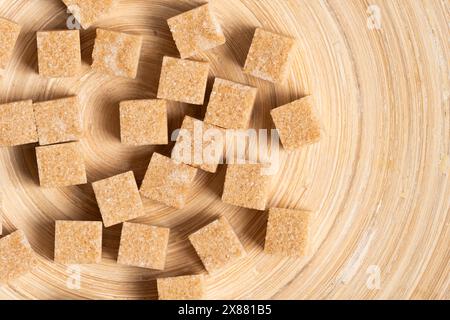 Cubes of refined cane sugar on wooden background Stock Photo