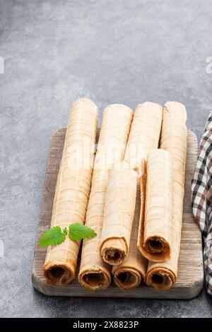 Delicious  of waffer rolls with boiled condensed milk on gray background Stock Photo