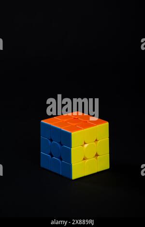 Salvador, Bahia, Brazil - May 15, 2024: Classic 3x3x3 Rubiks Cube on a black background. Rubiks Cube invented by Hungarian architect Erno Rubik in 197 Stock Photo