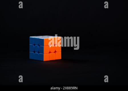 Salvador, Bahia, Brazil - May 15, 2024: Classic 3x3x3 Rubiks Cube on a black background. Rubiks Cube invented by Hungarian architect Erno Rubik in 197 Stock Photo