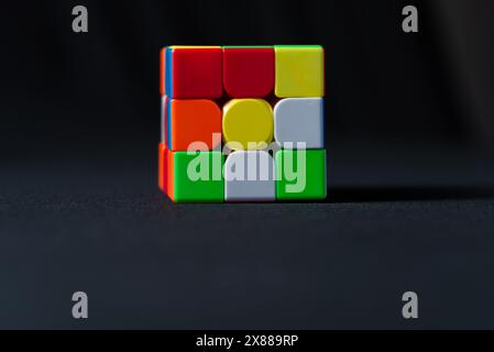 Salvador, Bahia, Brazil - May 15, 2024: Classic 3x3x3 Rubiks Cube on a black background. Rubiks Cube invented by Hungarian architect Erno Rubik in 197 Stock Photo