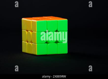 Salvador, Bahia, Brazil - May 15, 2024: Classic 3x3x3 Rubiks Cube on a black background. Rubiks Cube invented by Hungarian architect Erno Rubik in 197 Stock Photo