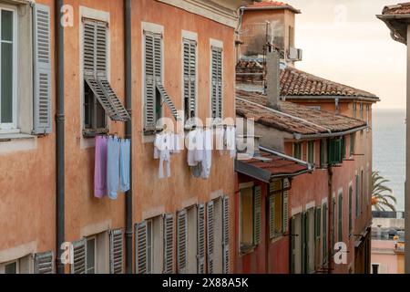 cloths hung on a clothsline to dry, outside an aparatment window, old town Stock Photo