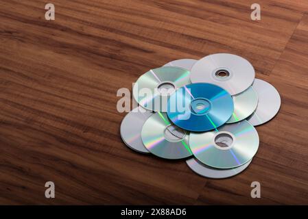 Many CDs isolated on wooden background. Music, mp3, files. Stock Photo