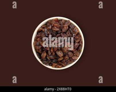 raisins on a white background in a bowl Stock Photo