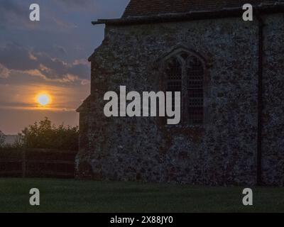 Harty, Kent, UK. 23rd May, 2024. UK Weather: the full Flower Moon seen rising next to Harty Church on the Isle of Sheppey in Kent. Credit: James Bell/Alamy Live News Stock Photo