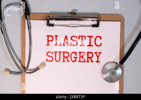 Plastic Surgery text on a wooden blocks on a table next to a stethoscope Stock Photo