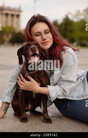 Woman with her cute German Shorthaired Pointer dog outdoors Stock Photo