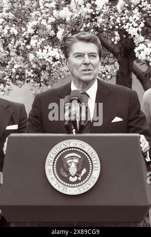 United States President Ronald Reagan (1911-2004) speaking from the White House Rose Garden in Washington, D.C., announcing a scholarship program for Caribbean students on April 14, 1983. (USA). Stock Photo