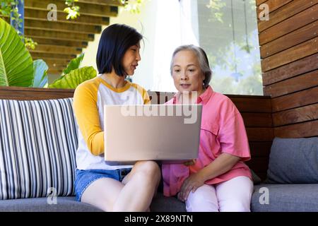 At home, Asian middle-aged mother and young adult daughter studying laptop Stock Photo