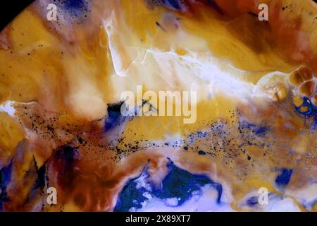 Photo of the texture of epoxy resin. Marble effects. Chaotic spots of different colors and shades. Yellow, orange, brown. White, black, blue. Colors m Stock Photo