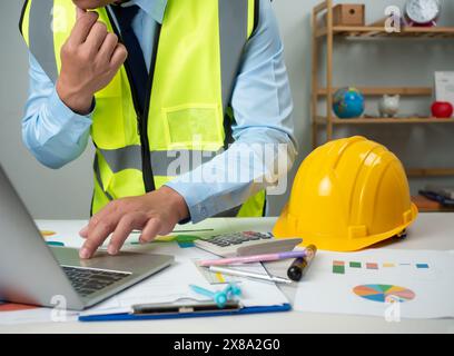 Architect or engineer using computer to work on desk, Cost calculation, Construction planning, Structural calculation, Construction cost planning, Str Stock Photo