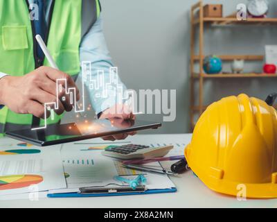 Architect or engineer using tablet to work on table, cost calculation, construction planning, structural calculation, construction cost planning, stru Stock Photo