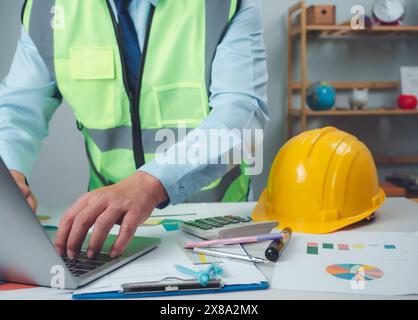 Architect or engineer using computer to work on desk, Cost calculation, Construction planning, Structural calculation, Construction cost planning, Str Stock Photo