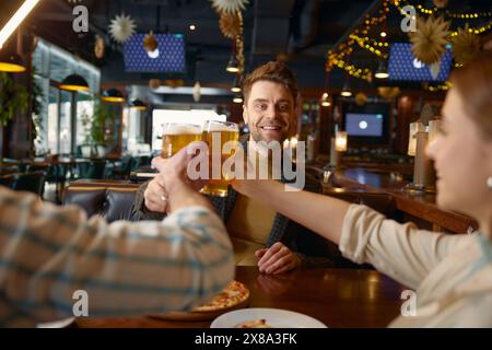 Friends drinking beer while rest in pub Stock Photo