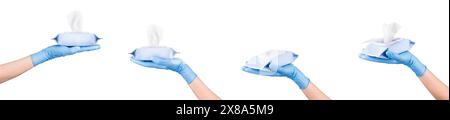 Woman hand in sterile gloves holding package of wet wipes or tissue isolated on a white background with clipping path. Concept of hygiene and protecti Stock Photo