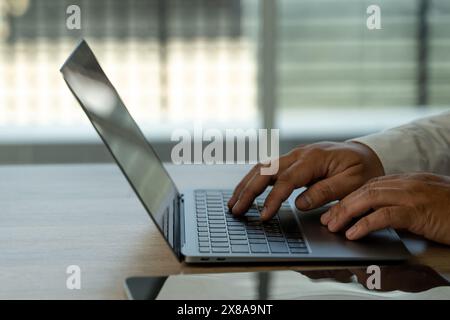 person Hands typing on laptop computer hand Close Up on Hands businessman Working at Laptop on table communication Stock Photo