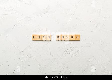 life hacks word written on wood block. life hacks text on table, concept. Stock Photo