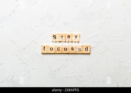 stay focused word written on wood block. stay focused text on table, concept. Stock Photo