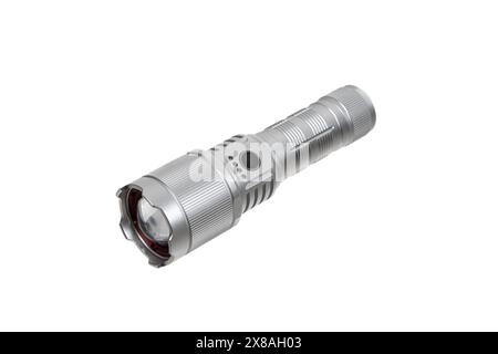 Modern metal LED flashlight in silver color. Portable flashlight isolate on a white background. Stock Photo