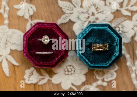 Wedding rings in red and teal velvet boxes on a lace background Stock Photo