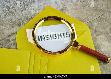 Insight concept. INSIGHTS word on paper sticking out of a mustard-colored envelope Stock Photo