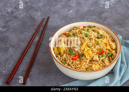 Asian Egg Chicken Fried Rice in a Bowl with Chopsticks High Angle Photo Stock Photo