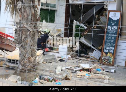 Palma, Spain. 24th May, 2024. A firefighter looks at part of the collapsed building. Two German women and two other people died in the collapse of a fully occupied restaurant in Playa de Palma on Mallorca. Credit: Clara Margais/dpa/Alamy Live News Stock Photo