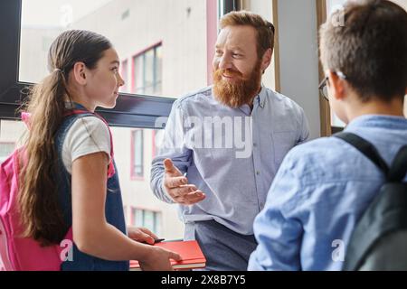 A bearded man is energetically teaching a diverse group of people in a bright, lively classroom setting. Stock Photo