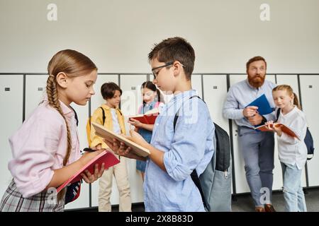 Two kids of different ethnicities standing close together, smiling happily in a bright, lively classroom as they bond. Stock Photo