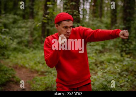 Man Practicing Boxing Moves in a Forest During a Spring Morning. Stock Photo