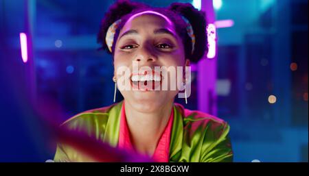 Woman, night and excited in office with neon, tablet or scroll for reading with problem solving at coding job. Person, girl and developer with click Stock Photo
