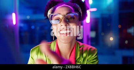 Woman, night and smile in office with neon, tablet and glasses for reading, information technology or coding. Person, girl and developer with click Stock Photo
