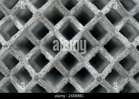 Three-dimensional openwork lattice, 3D-printed metal grid. Abstract technology background. Stock Photo