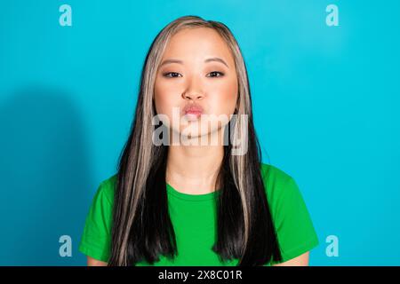 Portrait of nice young girl lips kiss wear t-shirt isolated on turquoise color background Stock Photo