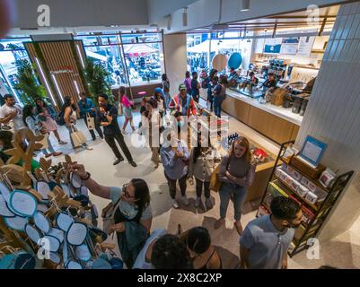 Customers and potential customers celebrate the grand opening of a branch of the Capital One Cafe in Union Square in New York on Saturday, May 18, 2024. Besides having a branch of the bank buried inside, the inviting cafe serves food and beverages and serves as a co-working space whether you are a customer or not.   (© Richard B. Levine) Stock Photo