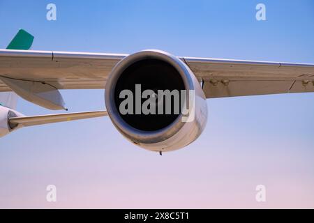 The jet engine of an airplane is on. These gas turbines are huge and loud while working full power. Stock Photo