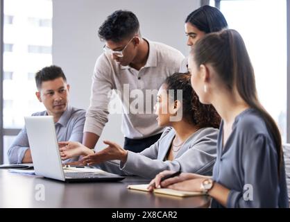 Laptop, meeting and teamwork with business people in boardroom of office together for training. Computer, training or workshop with man and woman Stock Photo