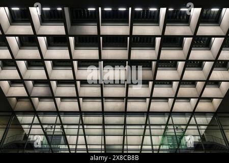 Symmetrical modern lighting and ceiling design of an office building Stock Photo
