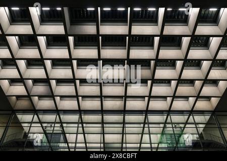 Symmetrical modern lighting and ceiling design of an office building Stock Photo