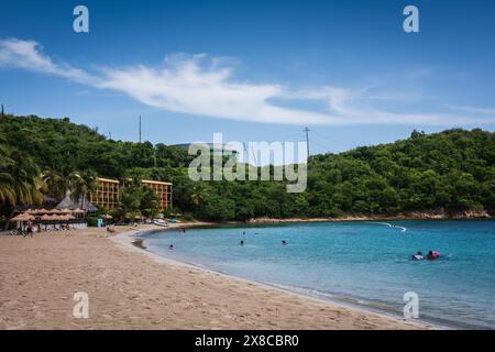 St. Thomas, US Virgin Islands - September 11, 2016: Tourists swimming in calm, clear waters at Emerald Beach near the airport in St. Thomas USVI. Stock Photo