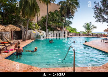 St. Thomas, US Virgin Islands - September 11, 2016: Tourists lounging in and by the pool at Emerald Beach Resort in St. Thomas, US Virgin Islands. Stock Photo