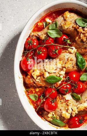 chicken legs backed with feta cheese tomatoes and pine nuts, healthy meal Stock Photo