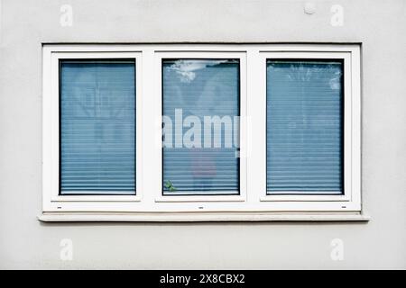Metal-plastic double-glazed window, in a white wall of a house, close-up Stock Photo