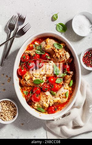 chicken legs backed with feta cheese tomatoes and pine nuts, healthy meal Stock Photo