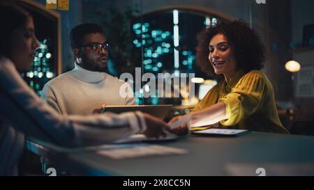 Group of Young Successful Businesspeople Making a Team Meeting in Conference Room in Creative Agency. Excited Diverse Team Discussing a New Digital Marketing Plan. Stock Photo