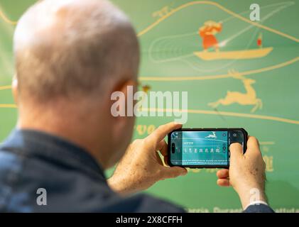 Rome, Italy. 24th May, 2024. A visitor learns about Chinese characters at an exhibition themed 'Code of Civilization in Chinese Characters' in Rome, Italy, May 24, 2024. Credit: Li Jing/Xinhua/Alamy Live News Stock Photo