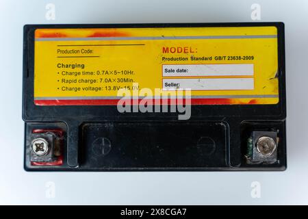A motorcycle battery displayed on a clean white background Stock Photo