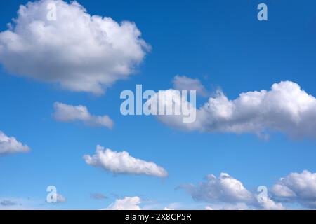 small soft cumulus fair weather clouds in a blue sky Stock Photo